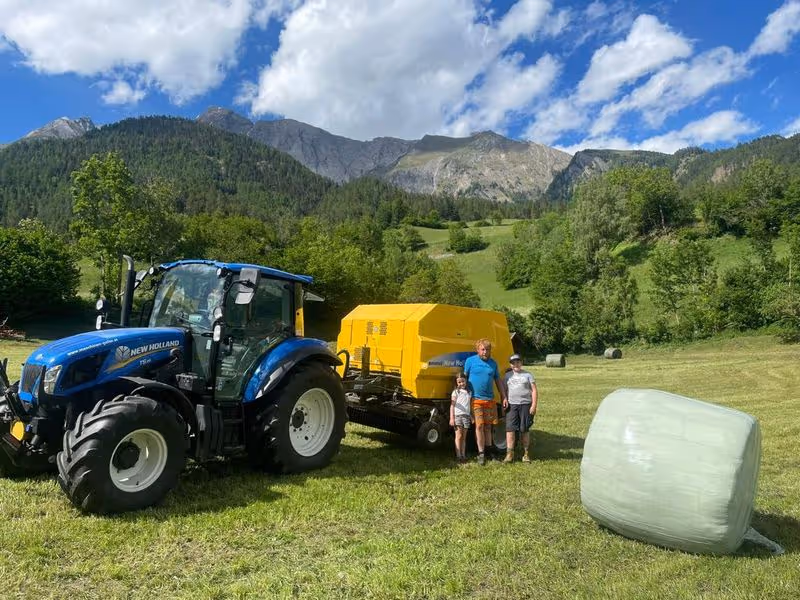 Traktor, Rundballenpresse und -wickler Übergabe