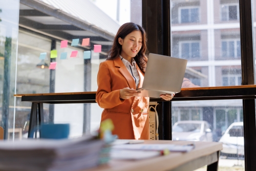 Professional woman reviewing training plan on laptop