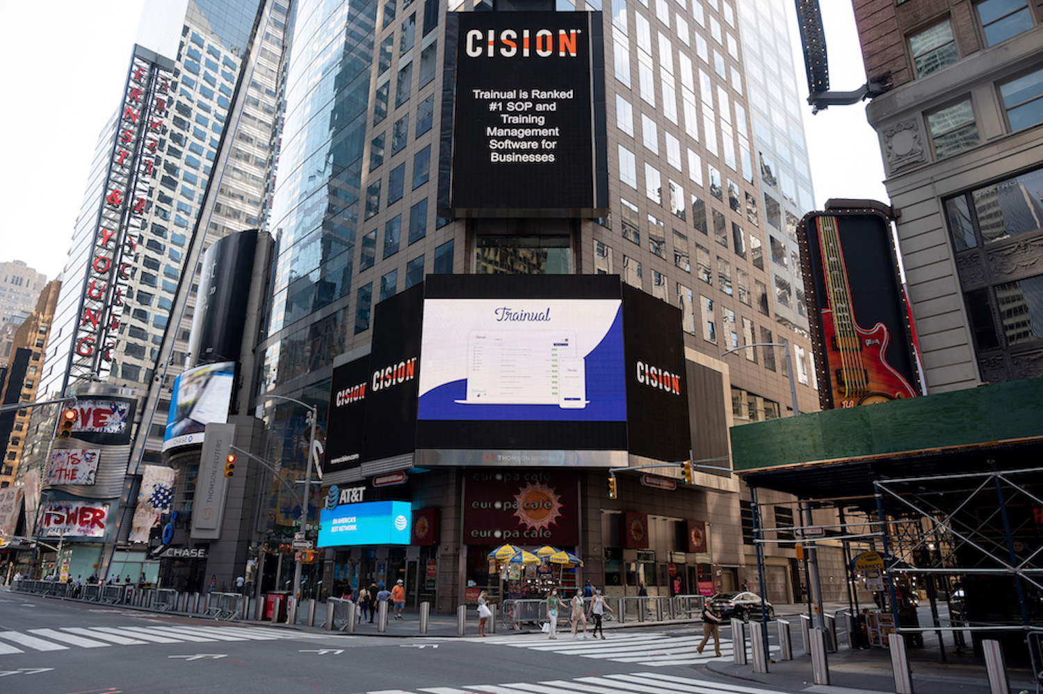 New York City Times Square billboard screen, featuring a laptop with the title Trainual. Also includes text "Trainual Is Ranked #1 SOP and Training Management Software for Businesses."