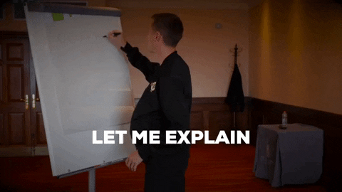 A man drawing on a posterboard saying, "Let me explain."