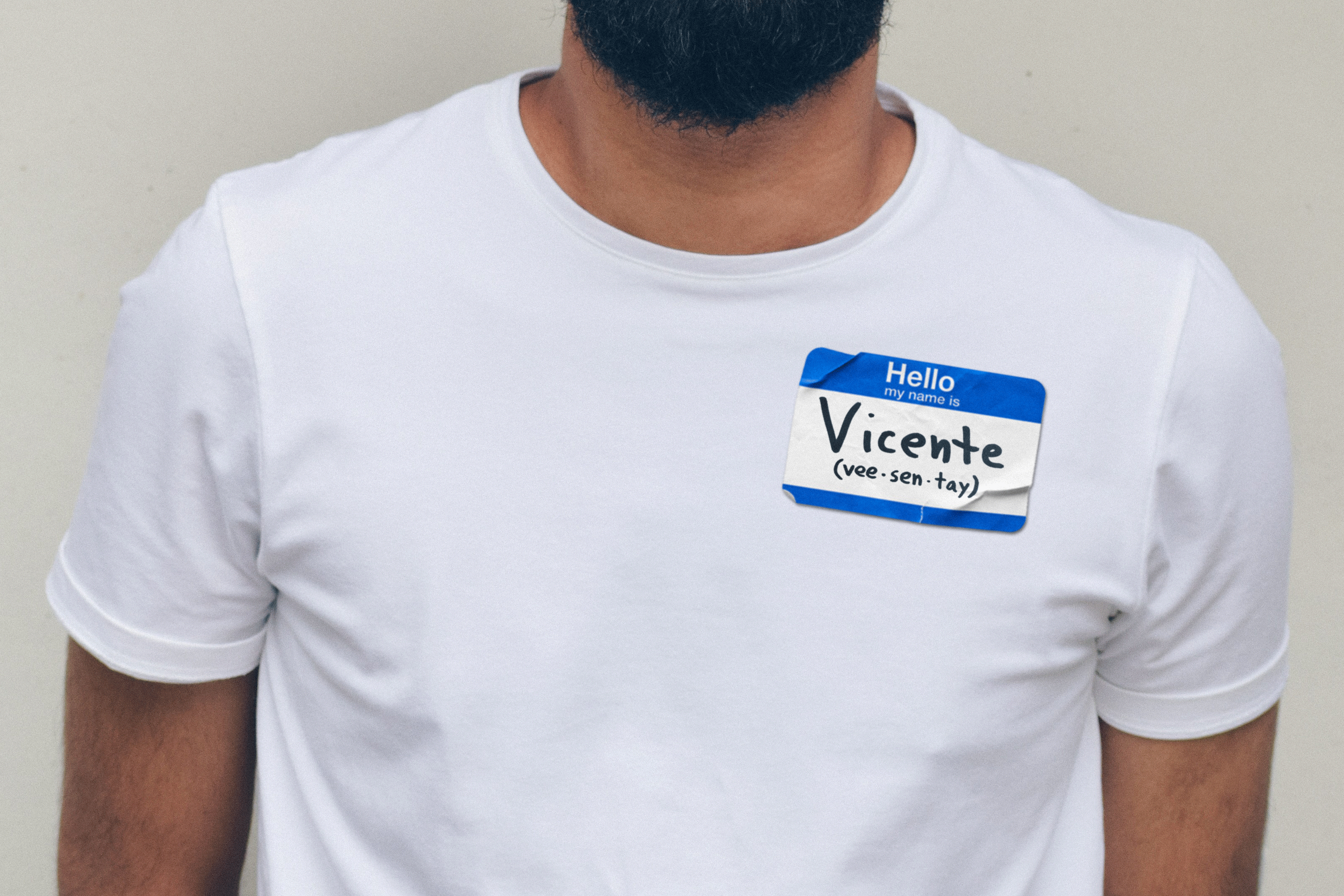 A man wearing a name tag that says, "Vicente (vee-sen-tay)."