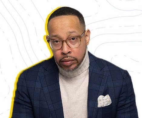 A man with glasses looking at the camera.