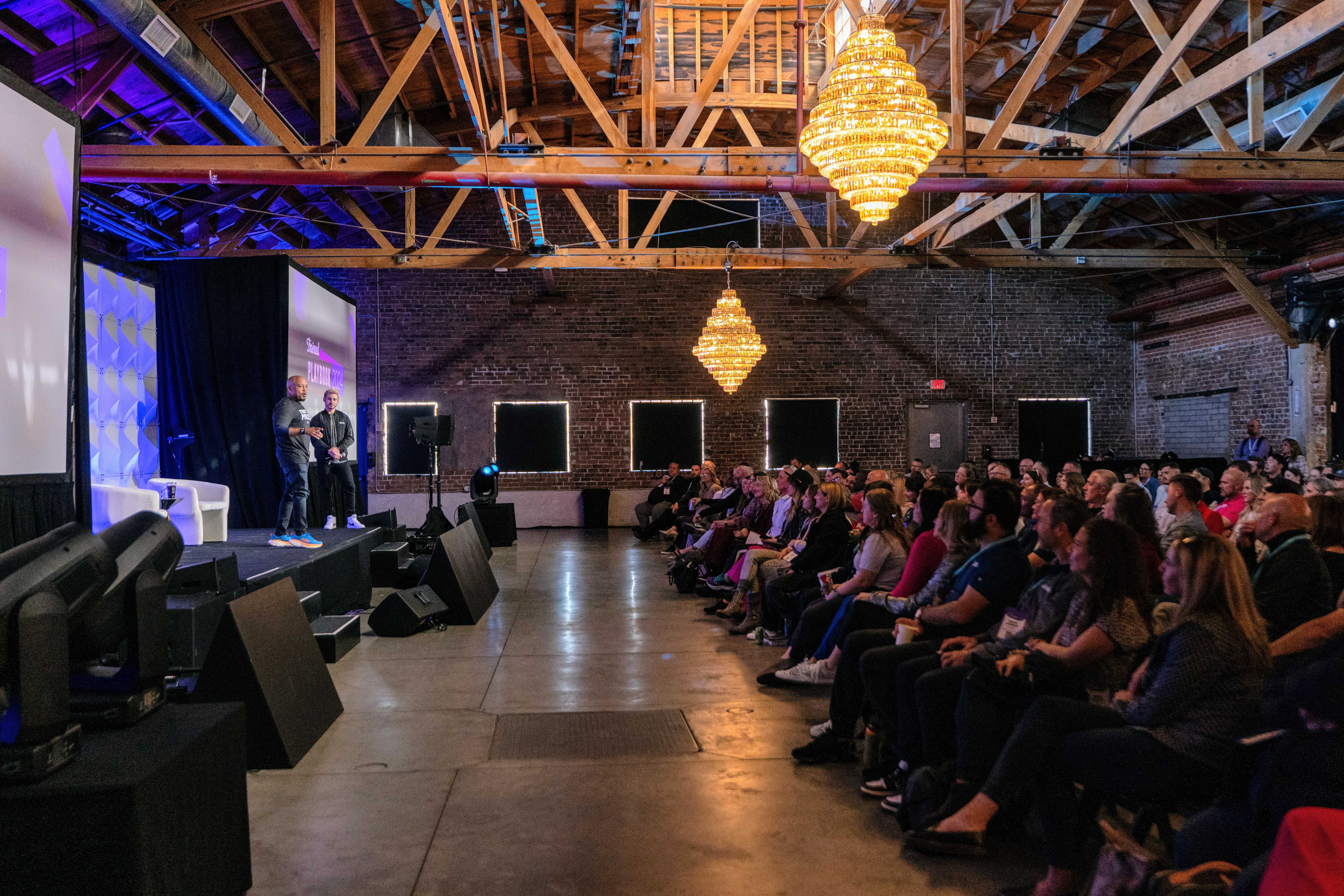 Trainual conference Playbook 2024 with a crowd of attendees.