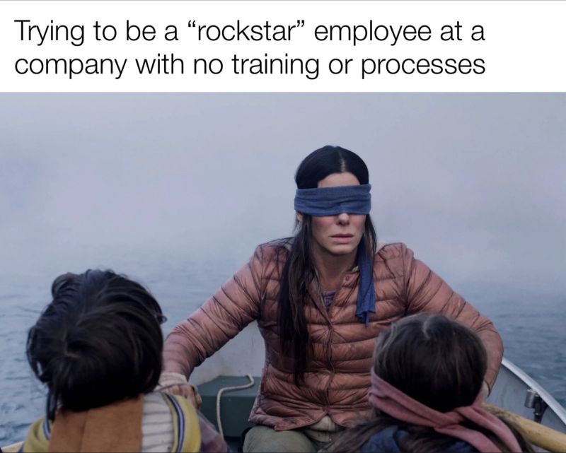 A woman in a blindfold rowing a boat.