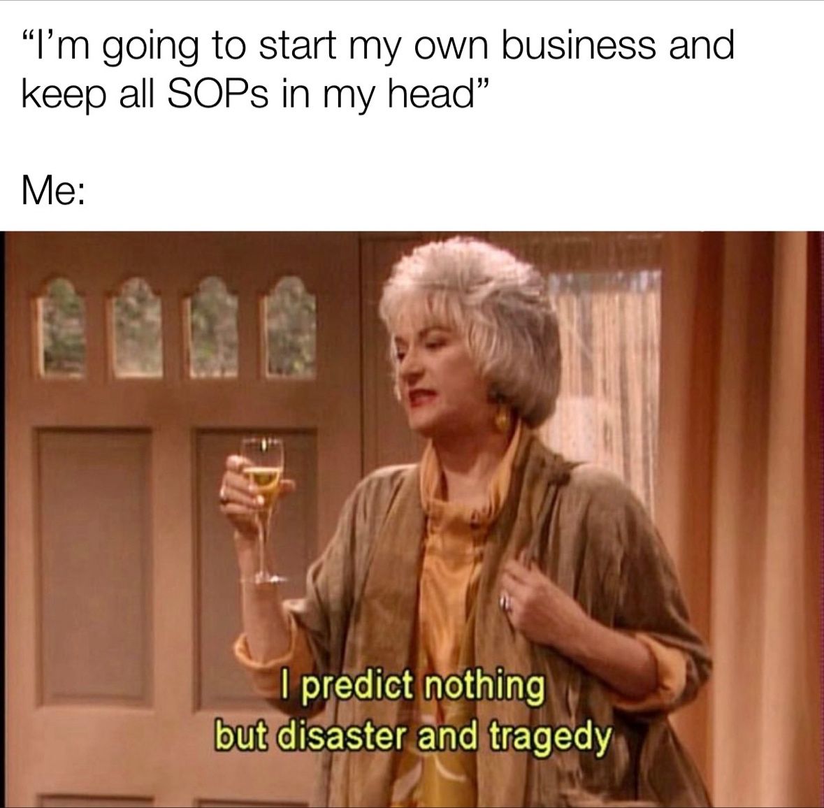 A woman holding a glass of wine.