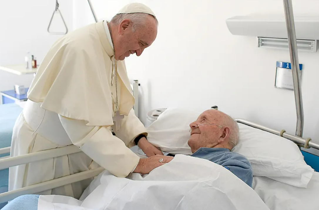 A priest anointing a hospital patient