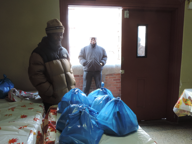 Food pantry volunteers with bagged groceries