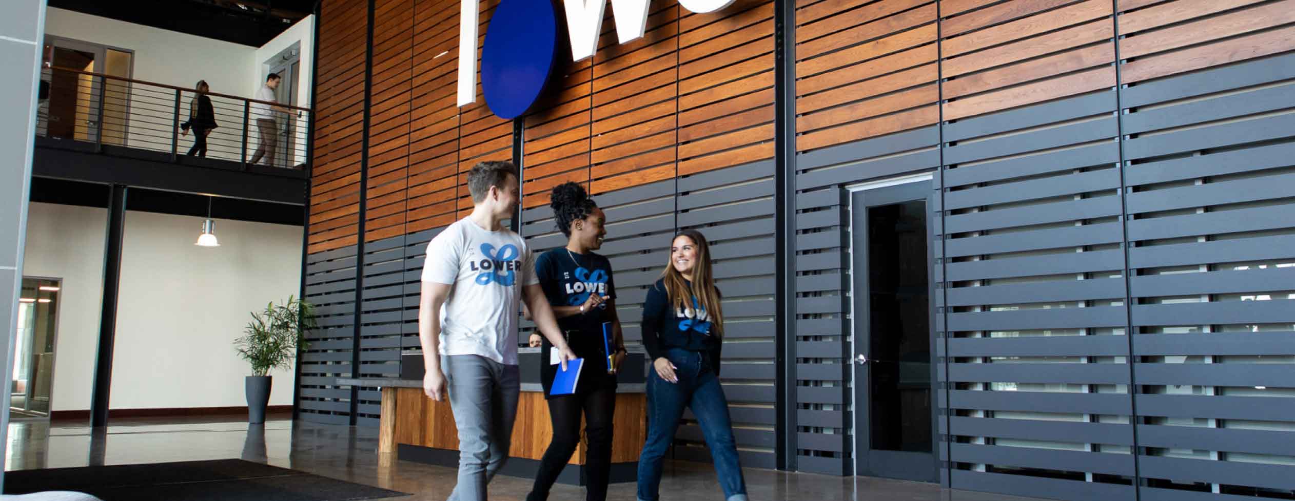 Lower.com headquarters lobby, employees walking