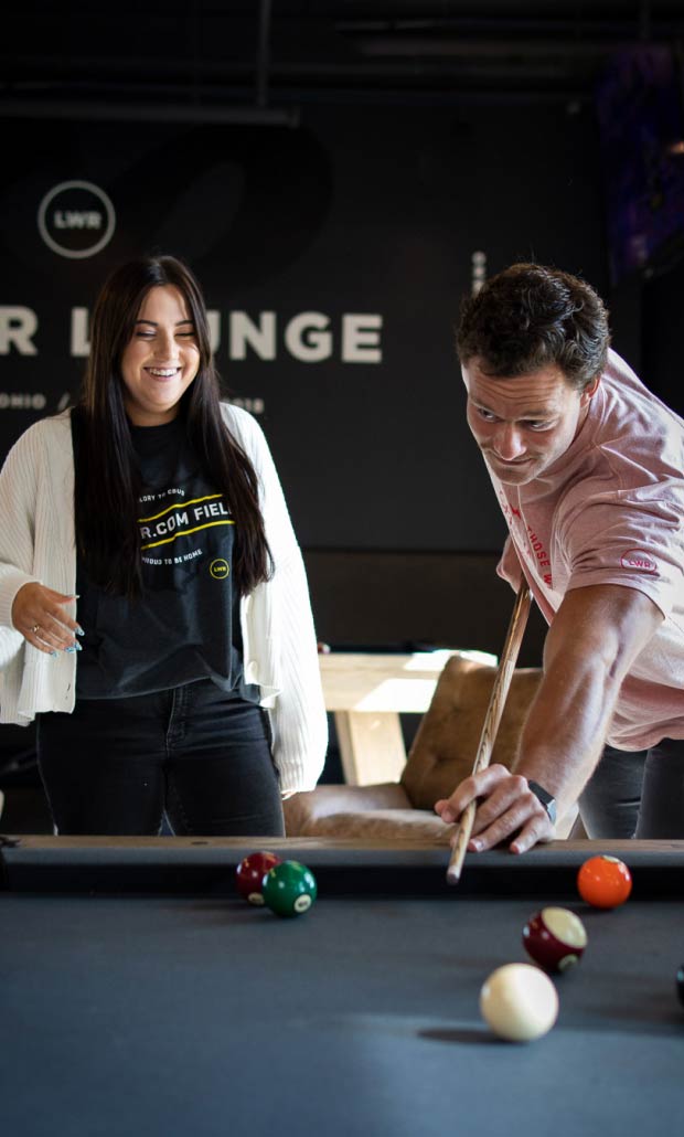 2 Lower employees playing pool in the Lower Lounges