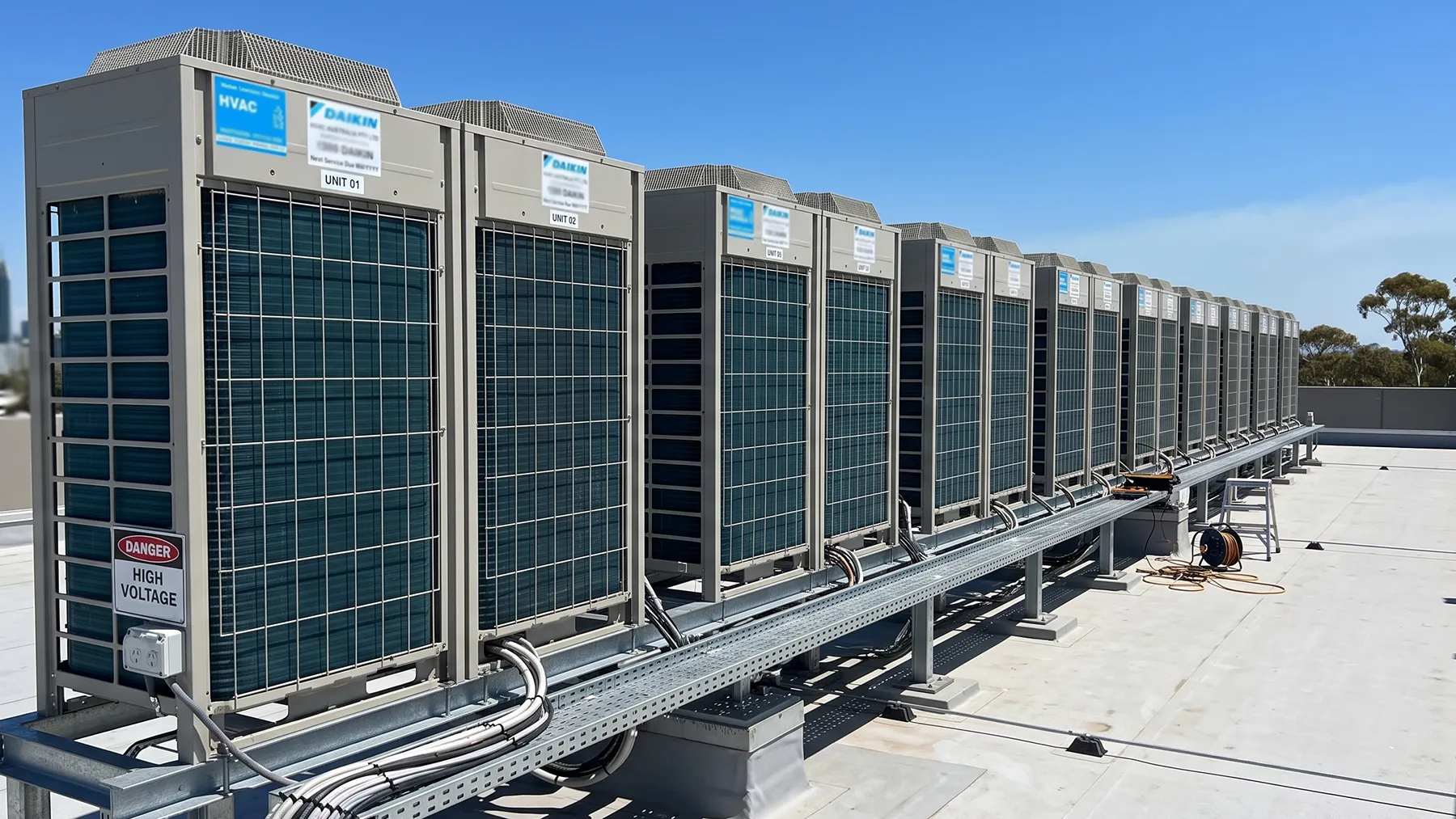 Row of Daikin commercial HVAC outdoor units installed on a building rooftop in Port Macquarie