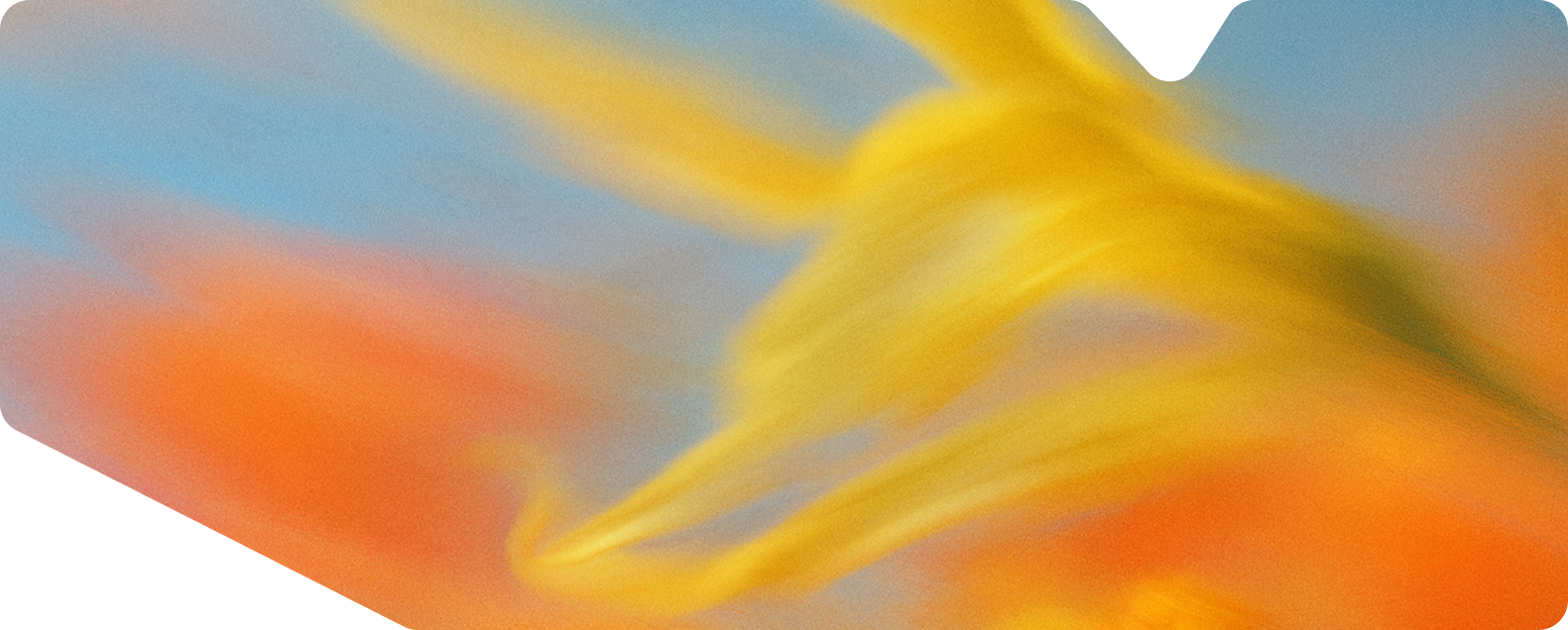 Abstract blurred swirls of yellow, orange, and blue colors creating a soft gradient effect.