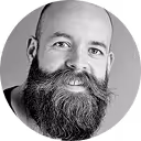 A black and white photo of a man with a beard.