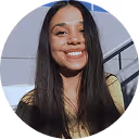 A woman with long hair smiling in a circle.