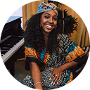 A woman sitting in front of a piano.