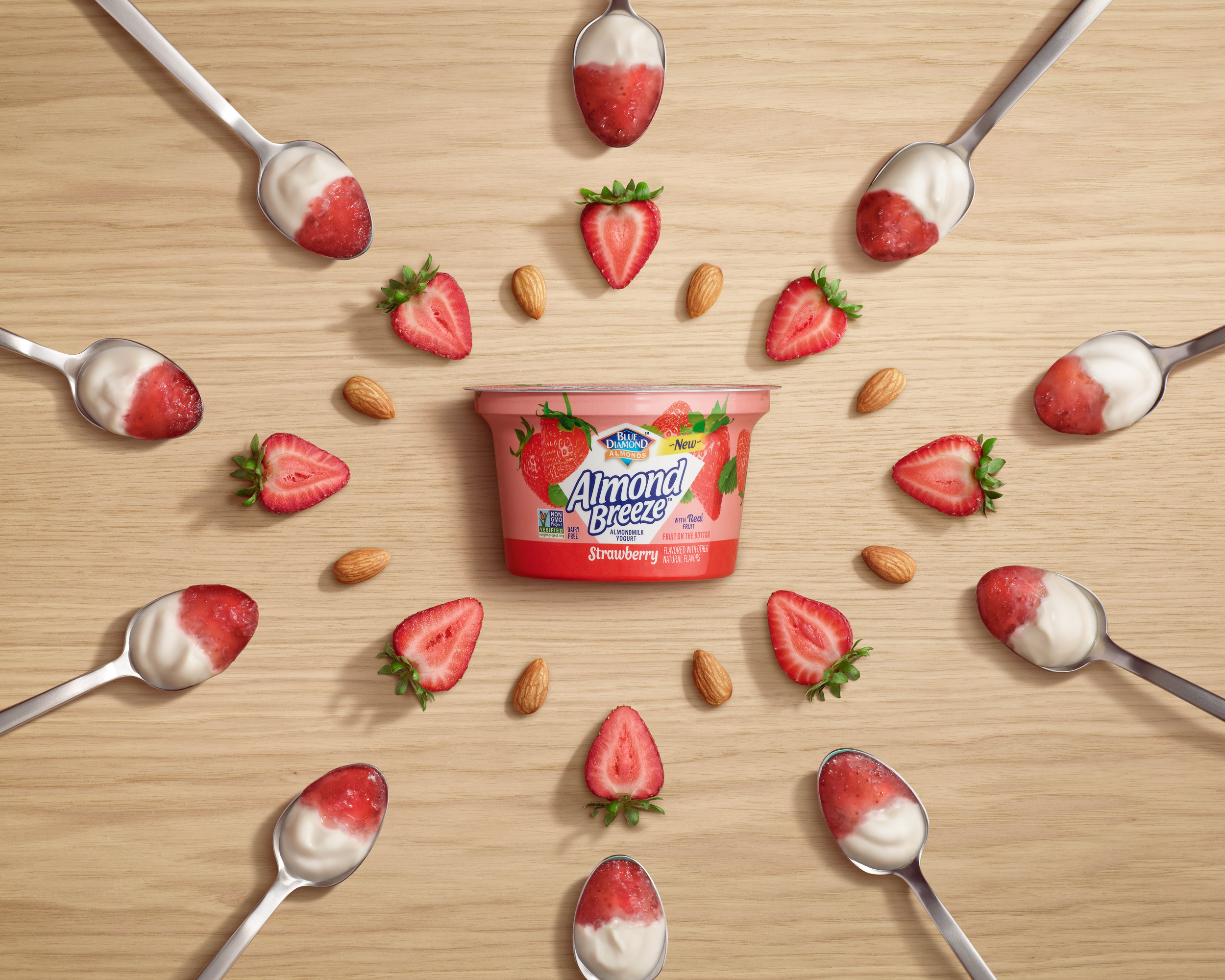 Yogurt placed on wooden background with strawberries
