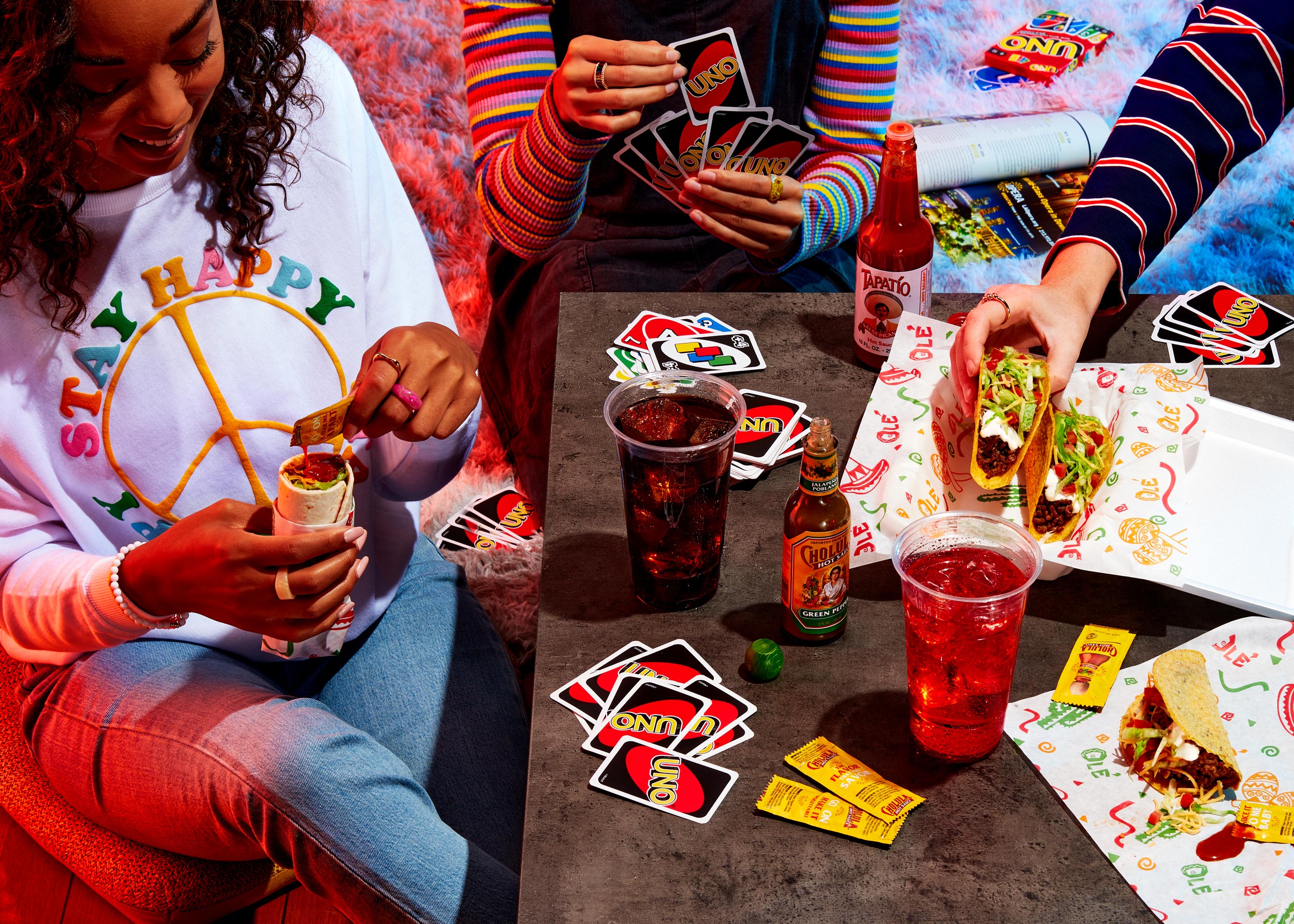 Friends enjoying Taco with Tapatío hot sauce and playing Uno