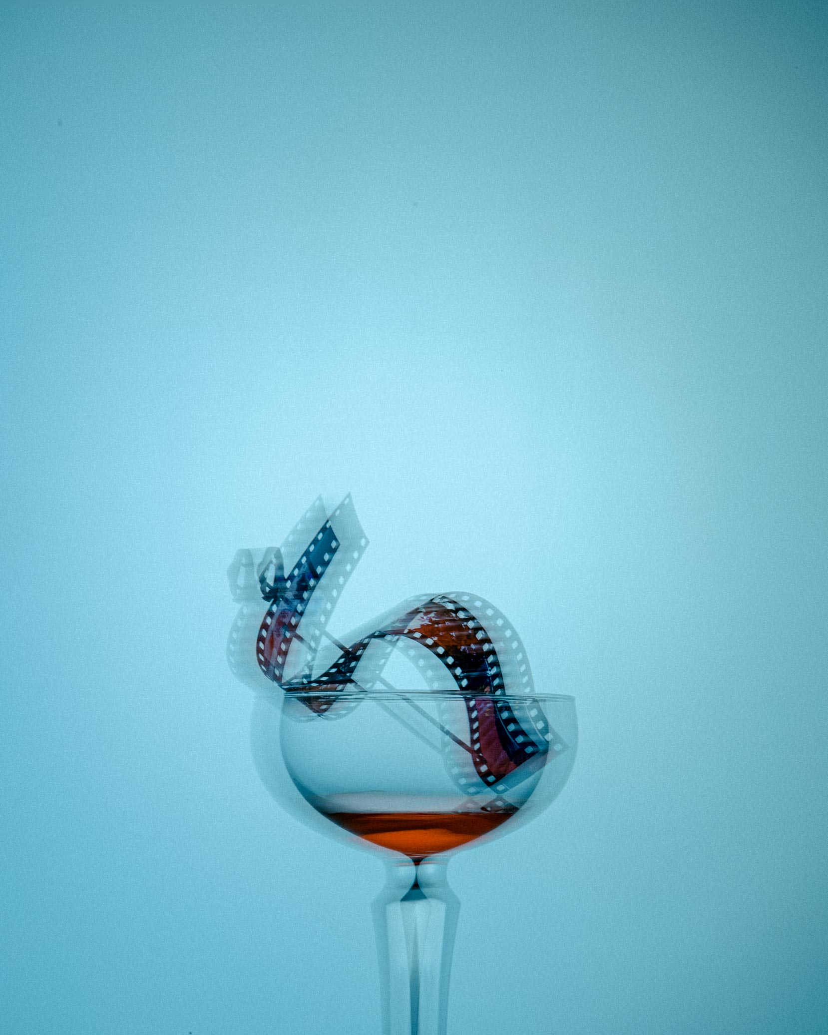 Single red chili pepper resting on a bed of dark roasted coffee beans.