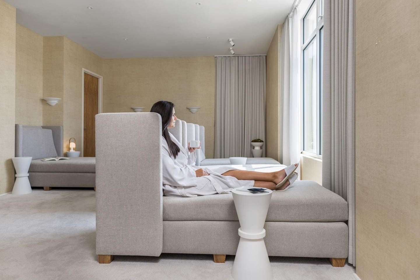 A lone woman relaxing at an indoor spa.