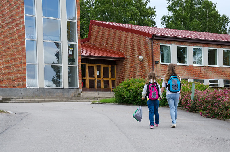 Two students outside of a school building