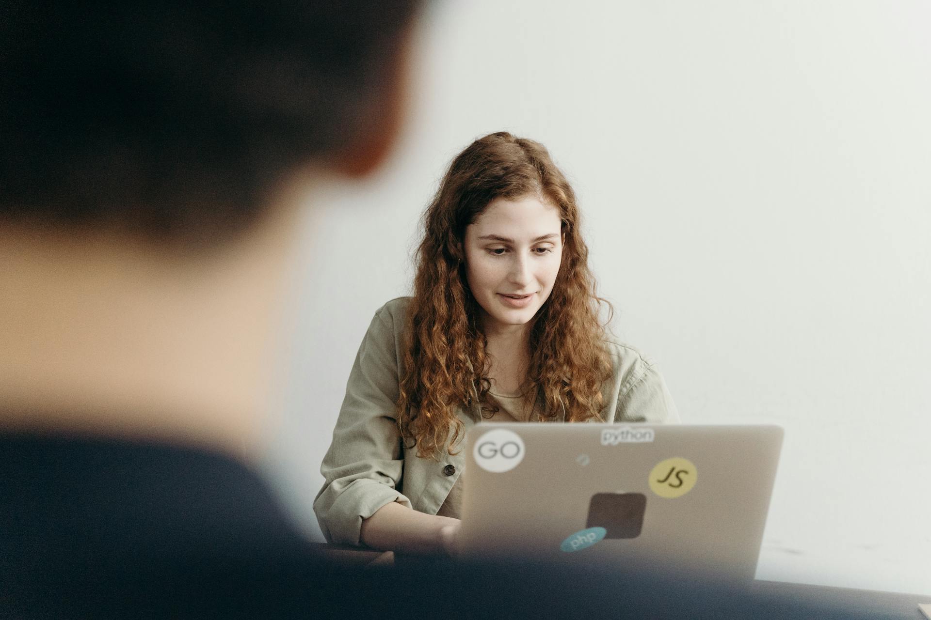 Woman smiling while using a laptop