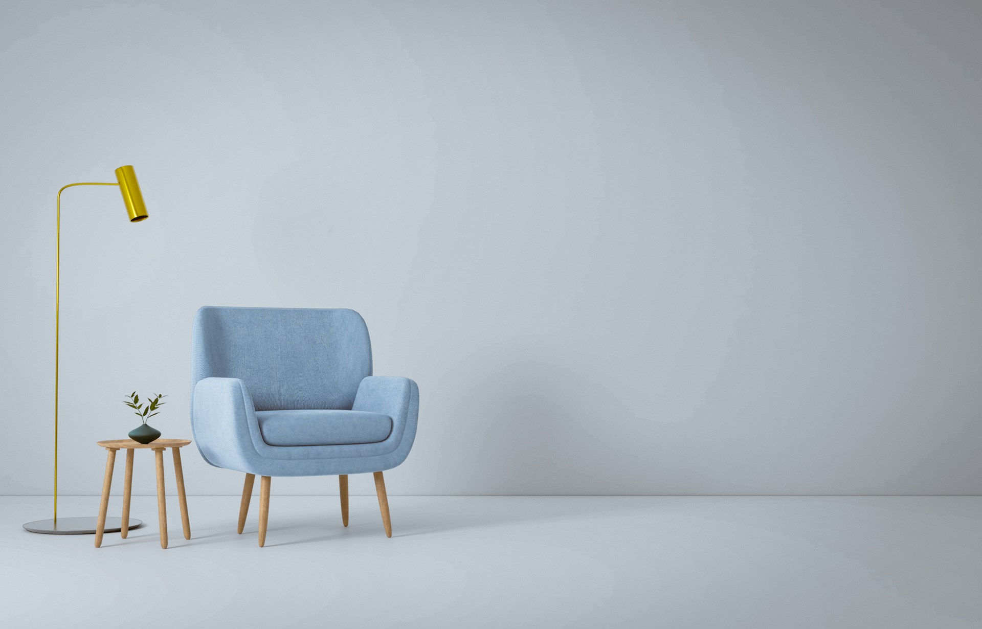 A blue chair, a coffee table, and a lamp in a white room