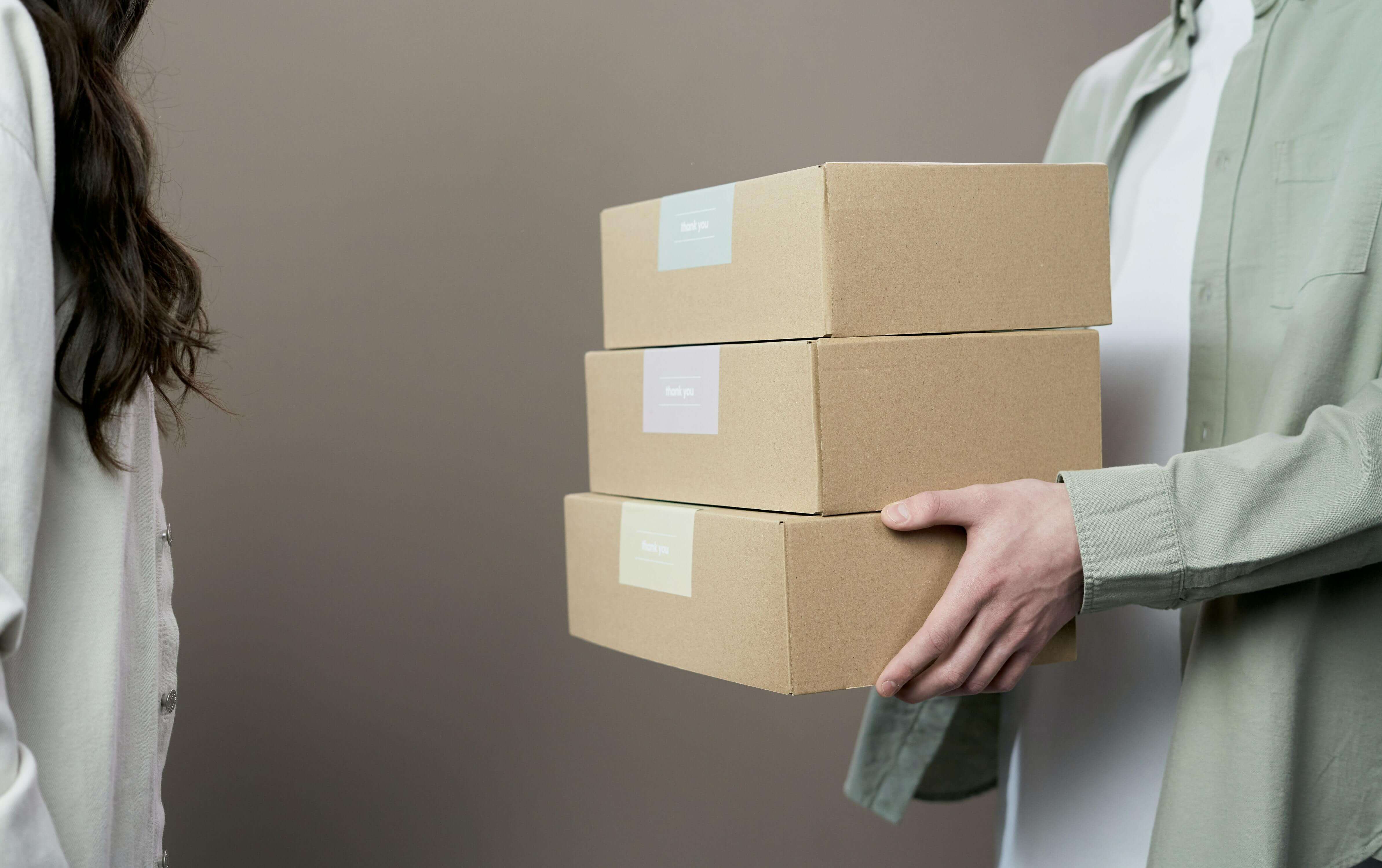 A person holding a cardboard box
