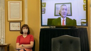Woman watching Tennessee Secretary of State Tre Hargett on television