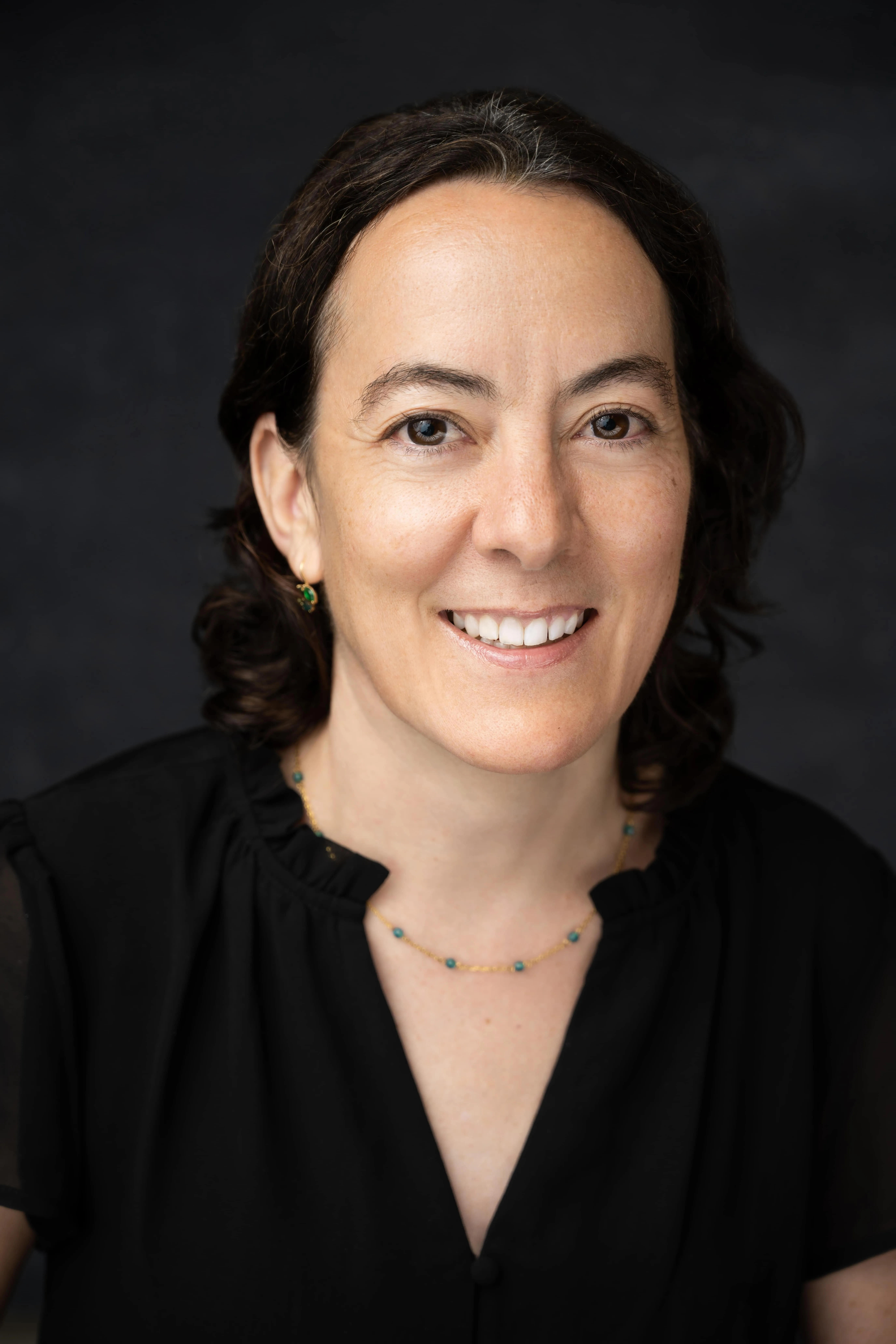 A woman with dark hair and a black shirt - New Leaders Images