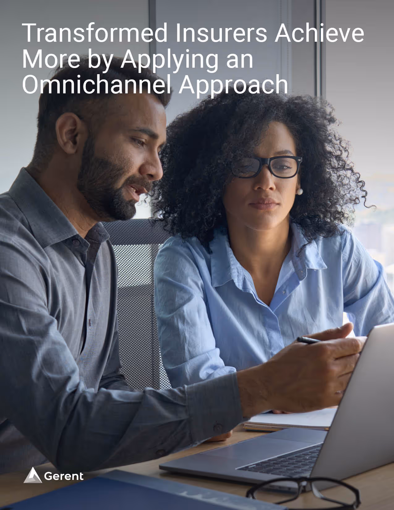 Two people discussing in front of a laptop