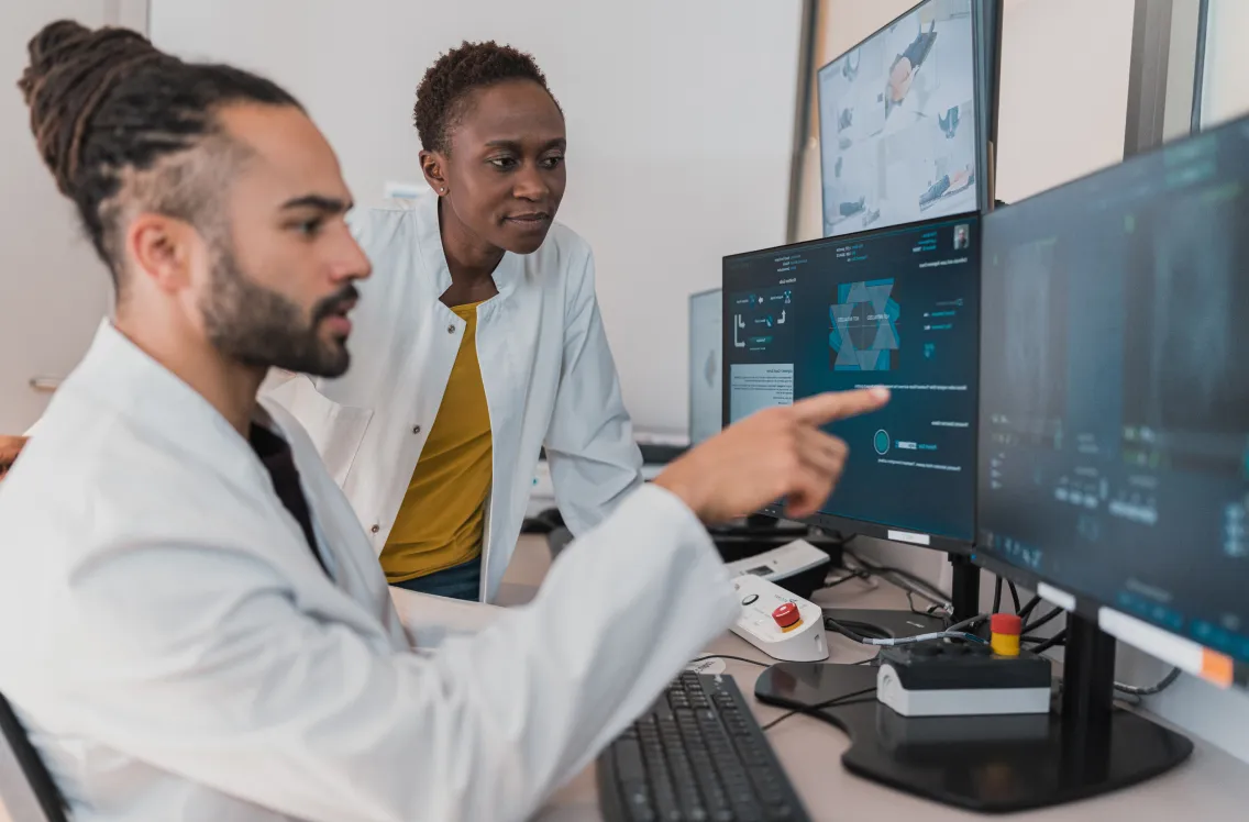 two ppl looking at a computer