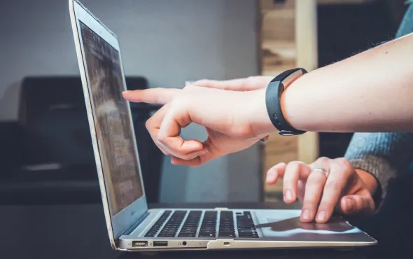 hands touching a computer screen
