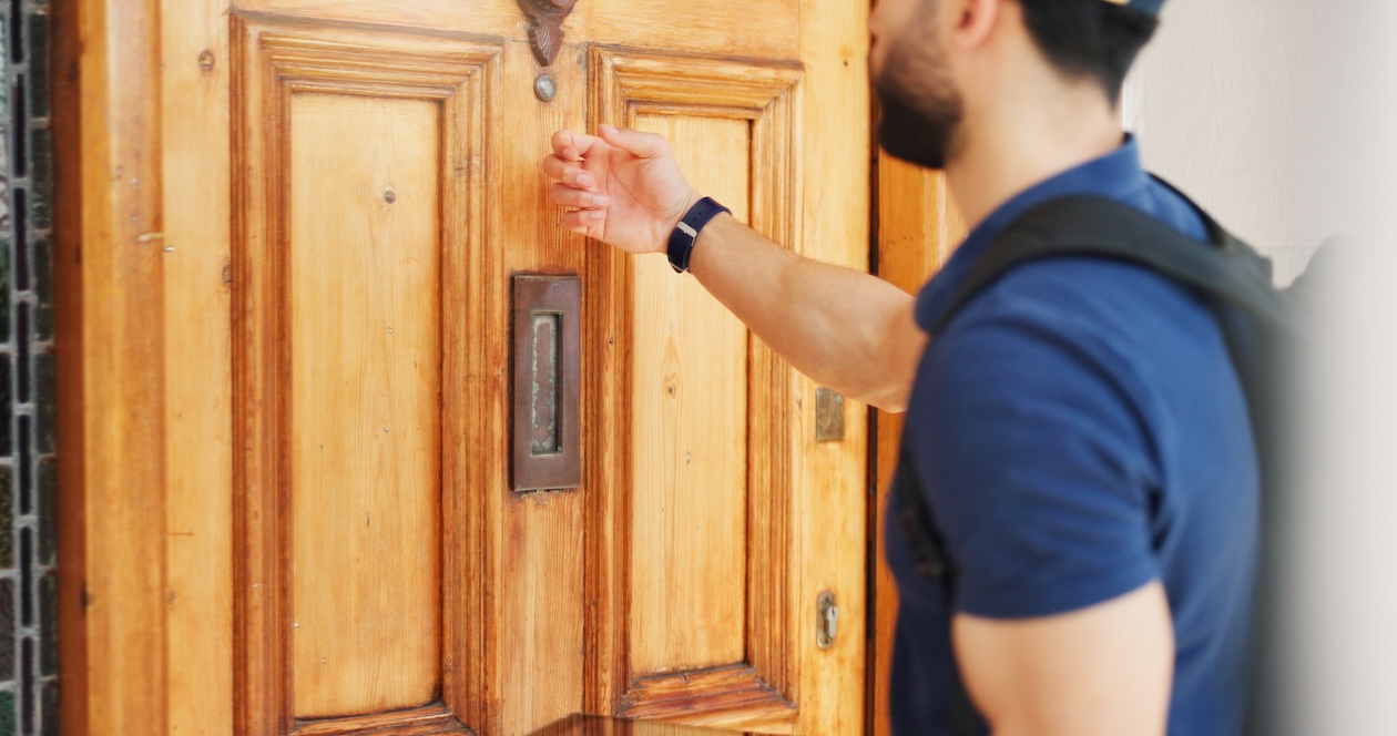 Technician knocking on a homeowner’s front door during a scheduled service visit.