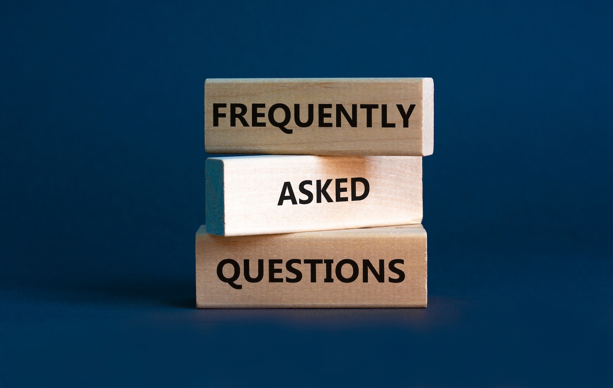 Blocks displaying the words “FAQ” and “Frequently Asked Questions” on a gray