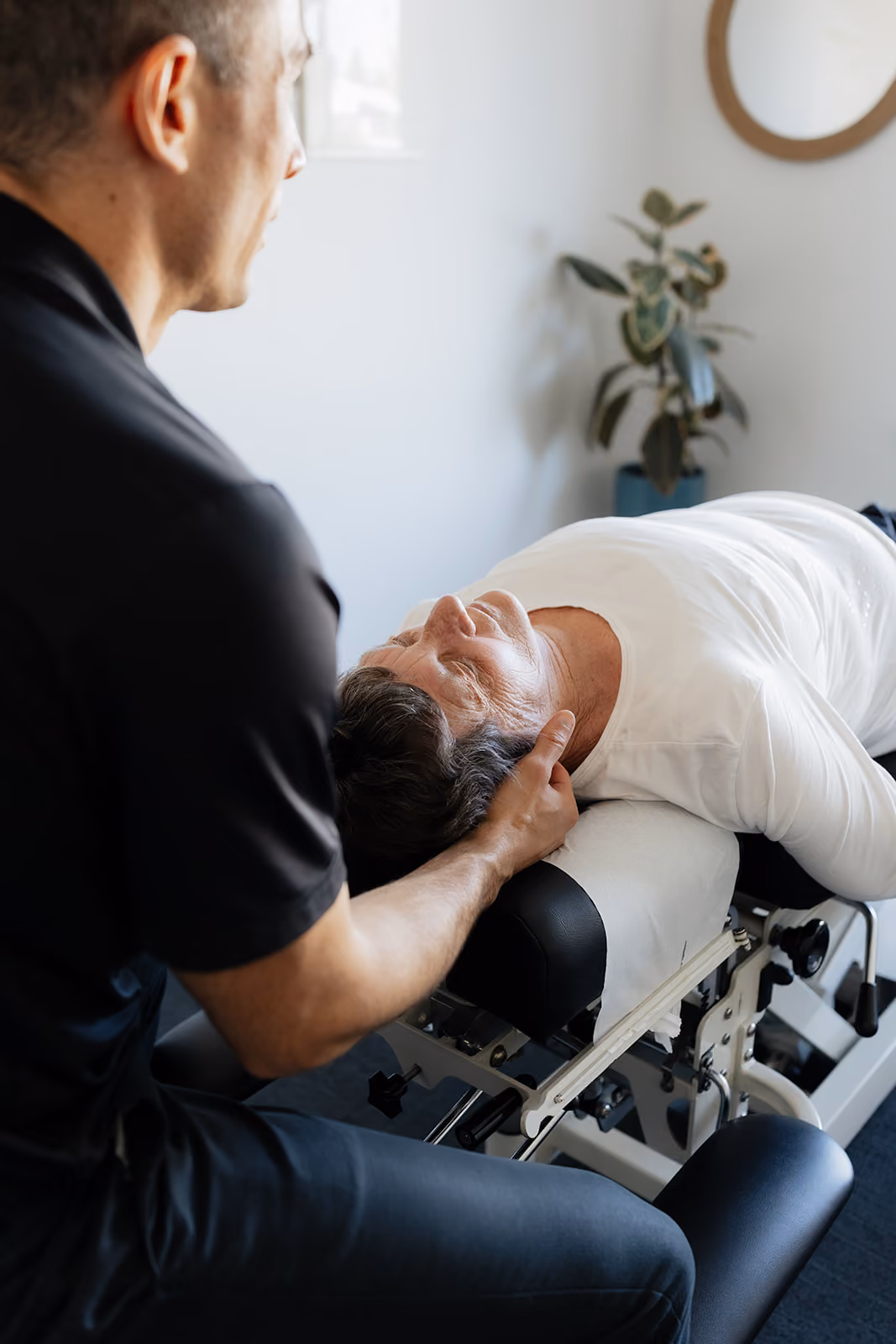 Senior patient receiving a gentle neck adjustment from a Busselton chiropractor