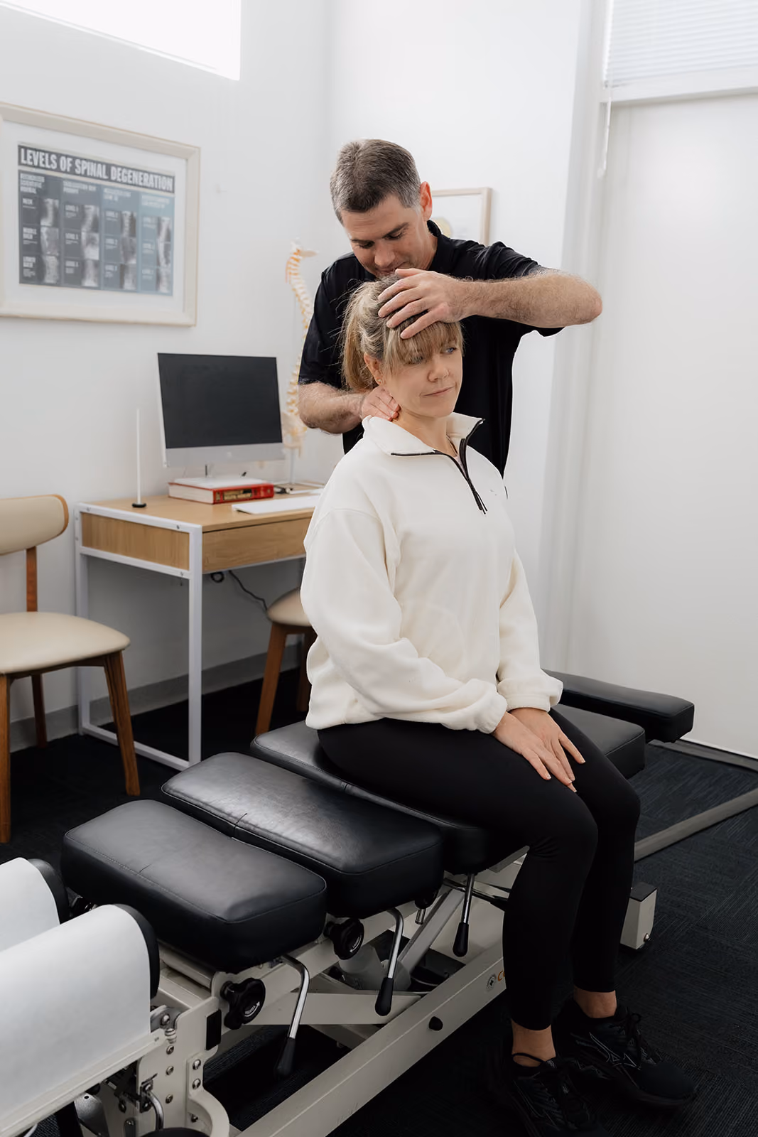 Woman receiving a gentle chiropractic neck adjustment at Beachside Chiropractic Busselton