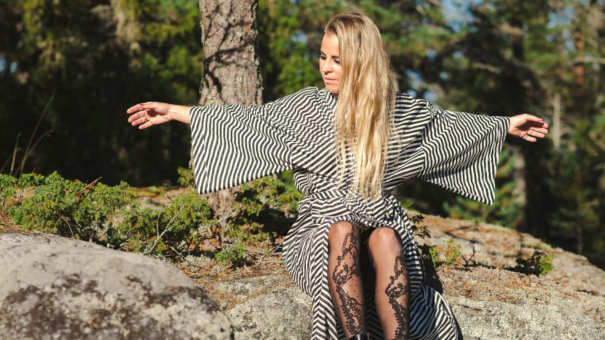 island with red lighthouse and red buildings in the middle of the sea