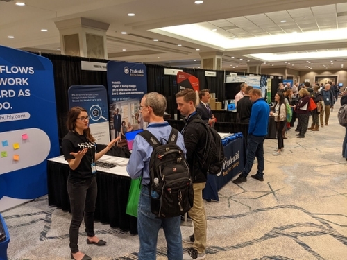 Girl at Hubly booth at XYPN Conference booth 2022 talking to attendees