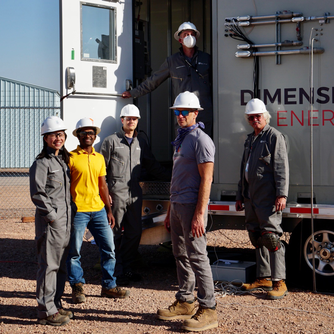 Team photo standing outside a truck.