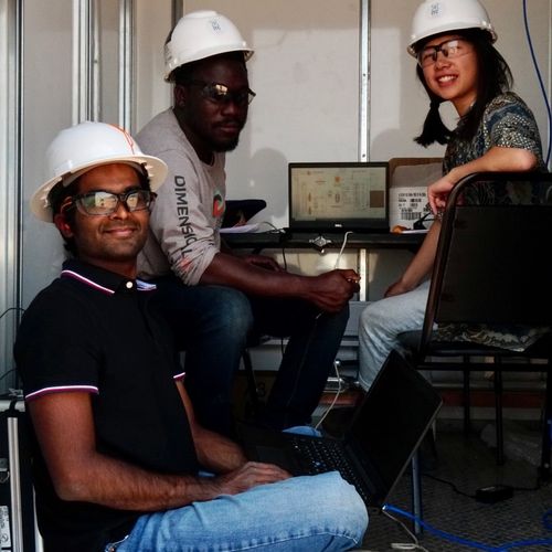 Photo of Dimensional Energy employees working at a computer.