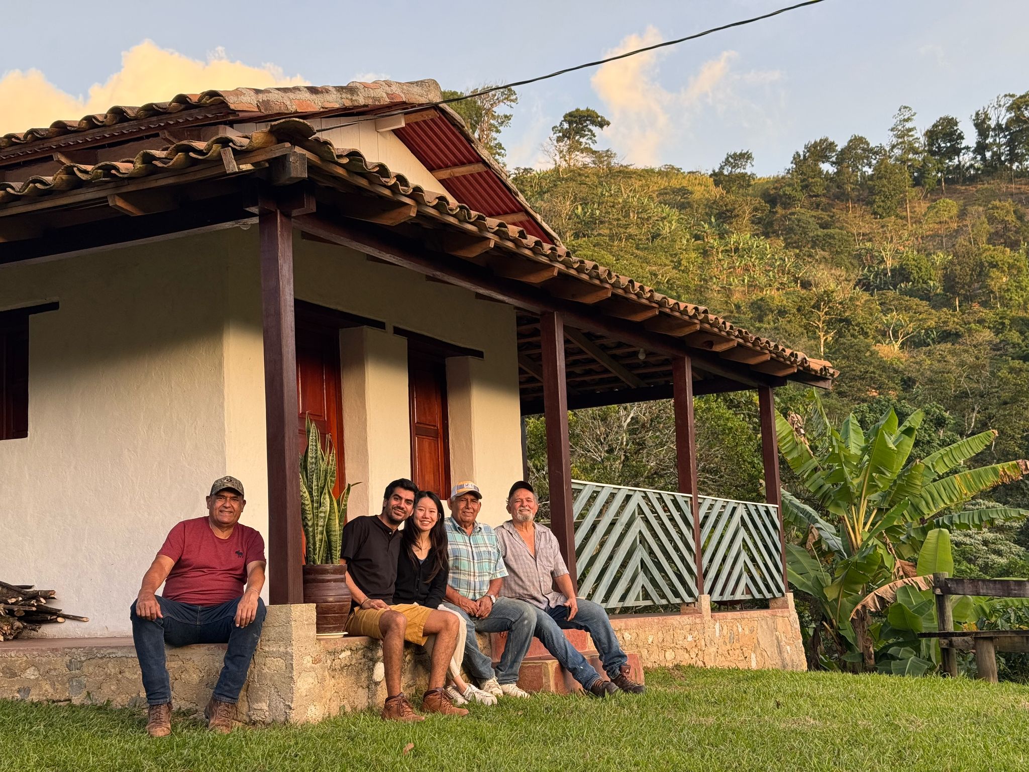 Five of us sitting on the porch of the house at sunset hour