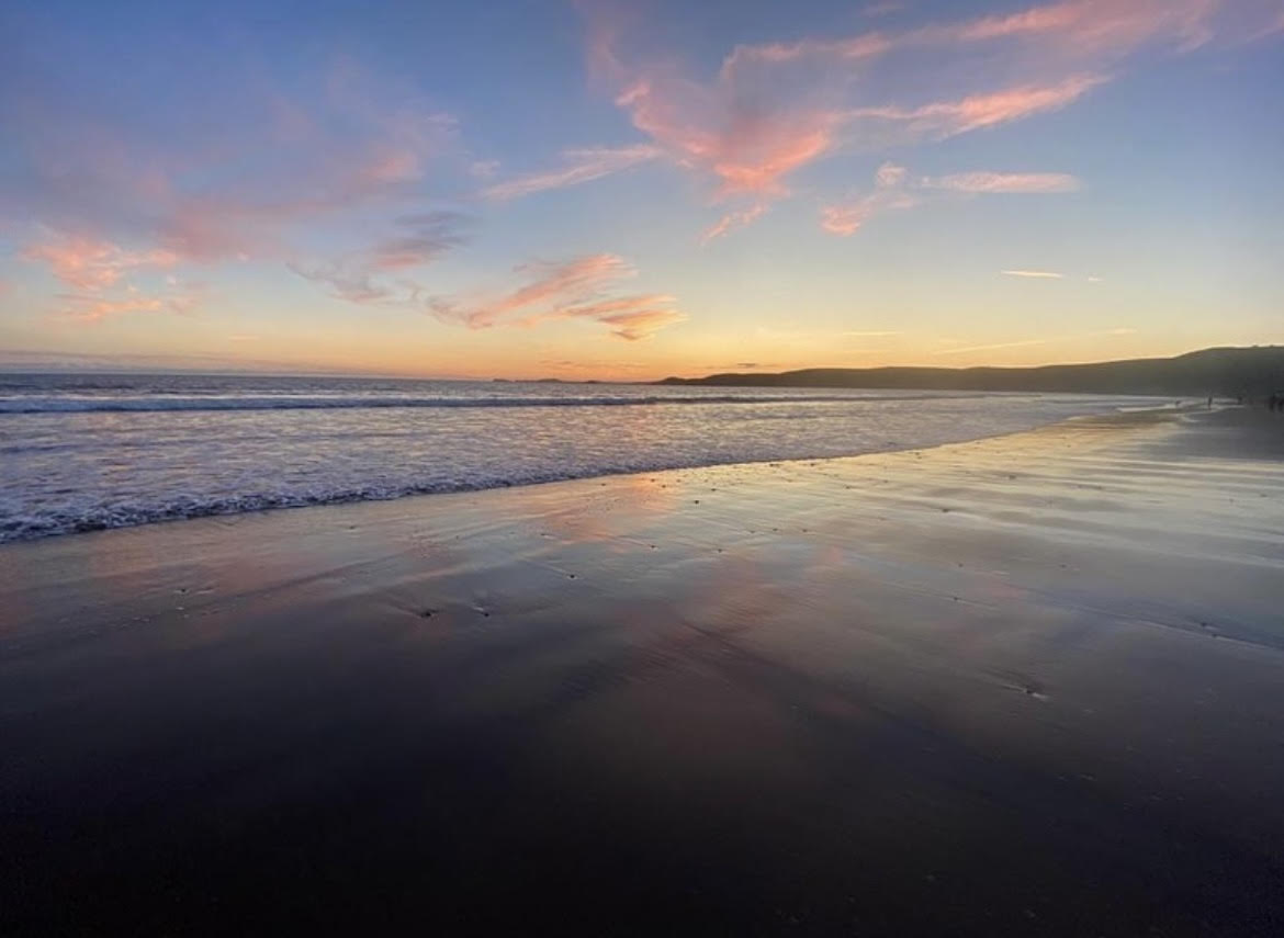 Evening sky over wet sandy beach 