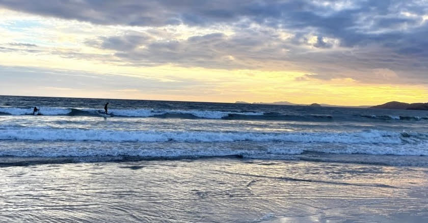 Surfing waves at sunset 