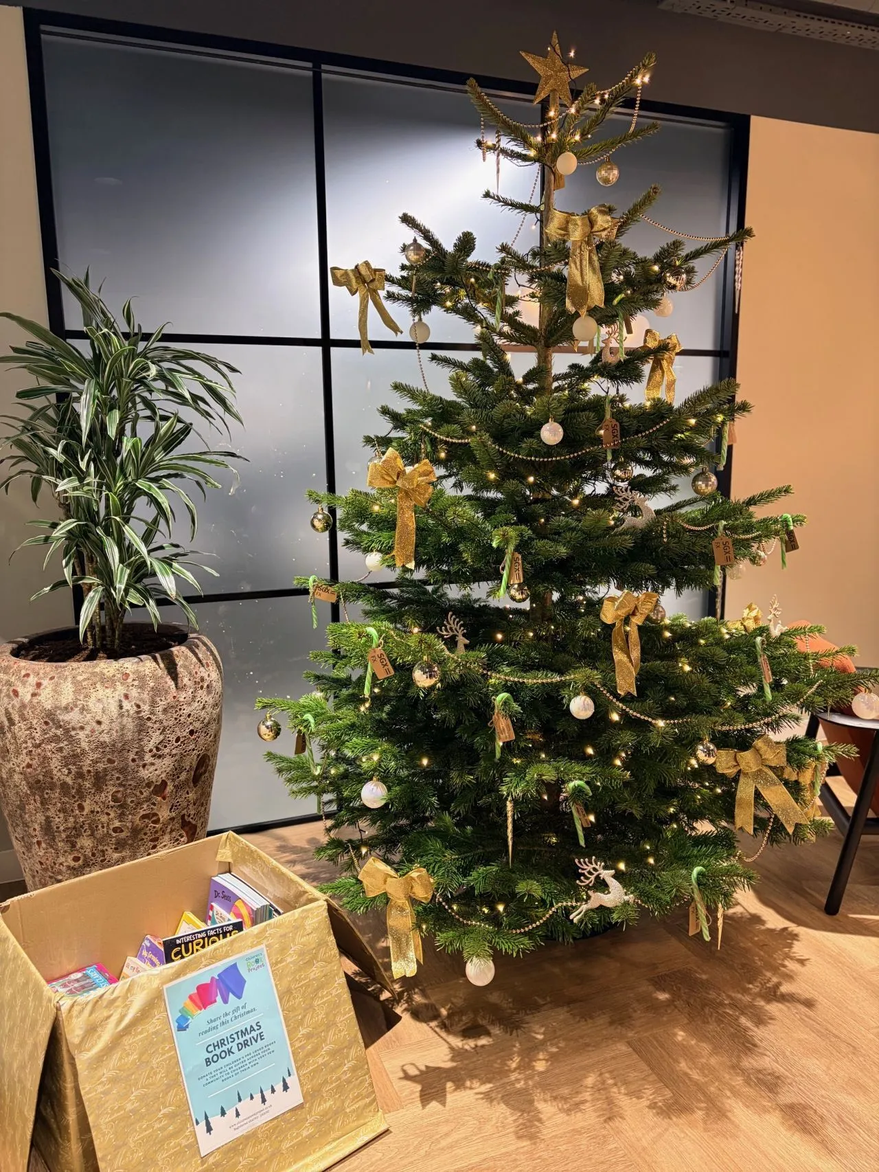 Christmas tree with branded decorations in a client office