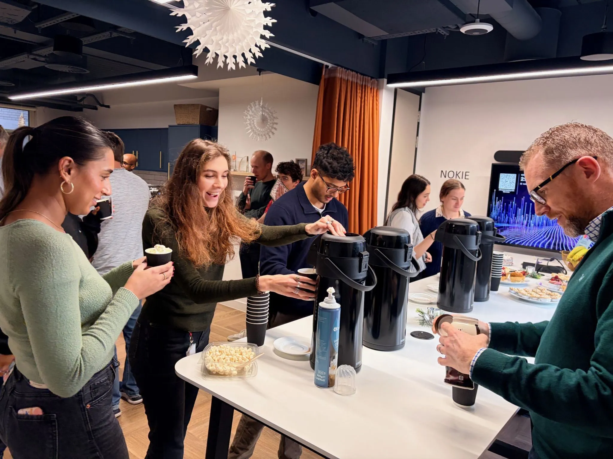 The SGX FX team serving hot chocolate at their office Christmas