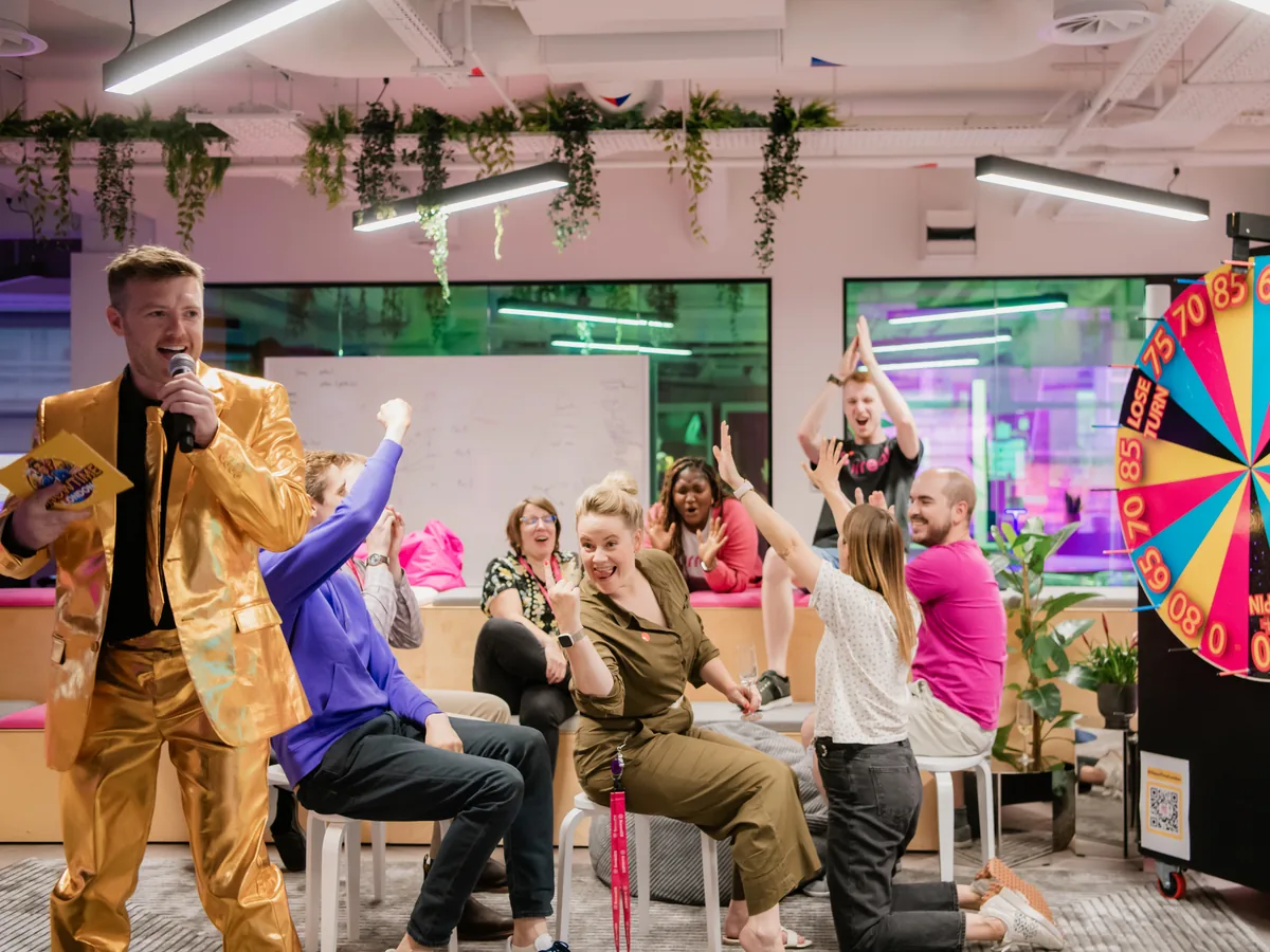 Game show host running a party game in an office
