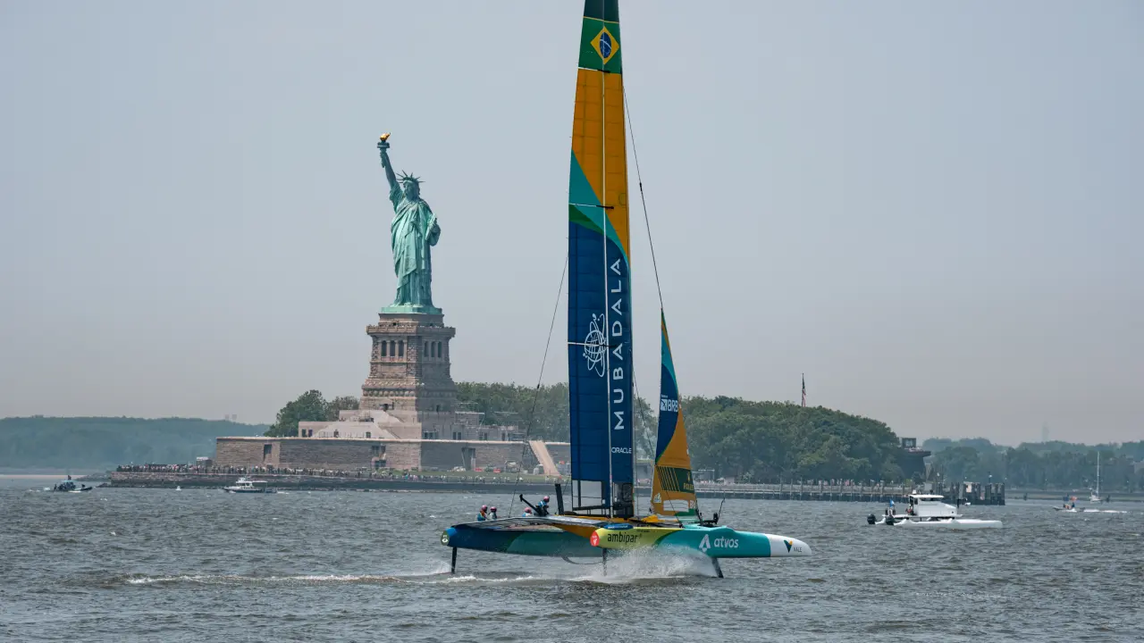 The Mubadala Brazil SailGP team races past the Statue of Liberty