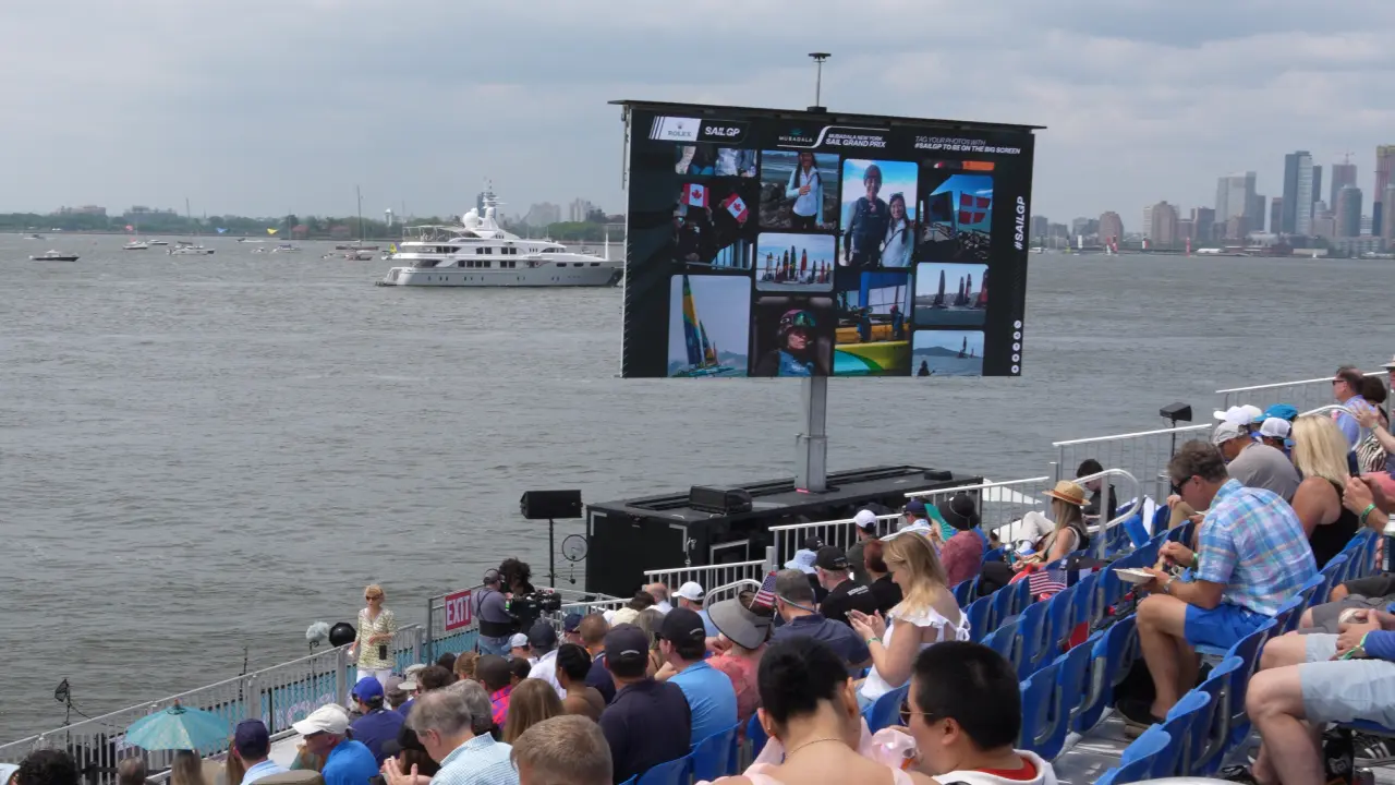 Fans sit in front of a Jumbotron displaying SailGP's broadcast
