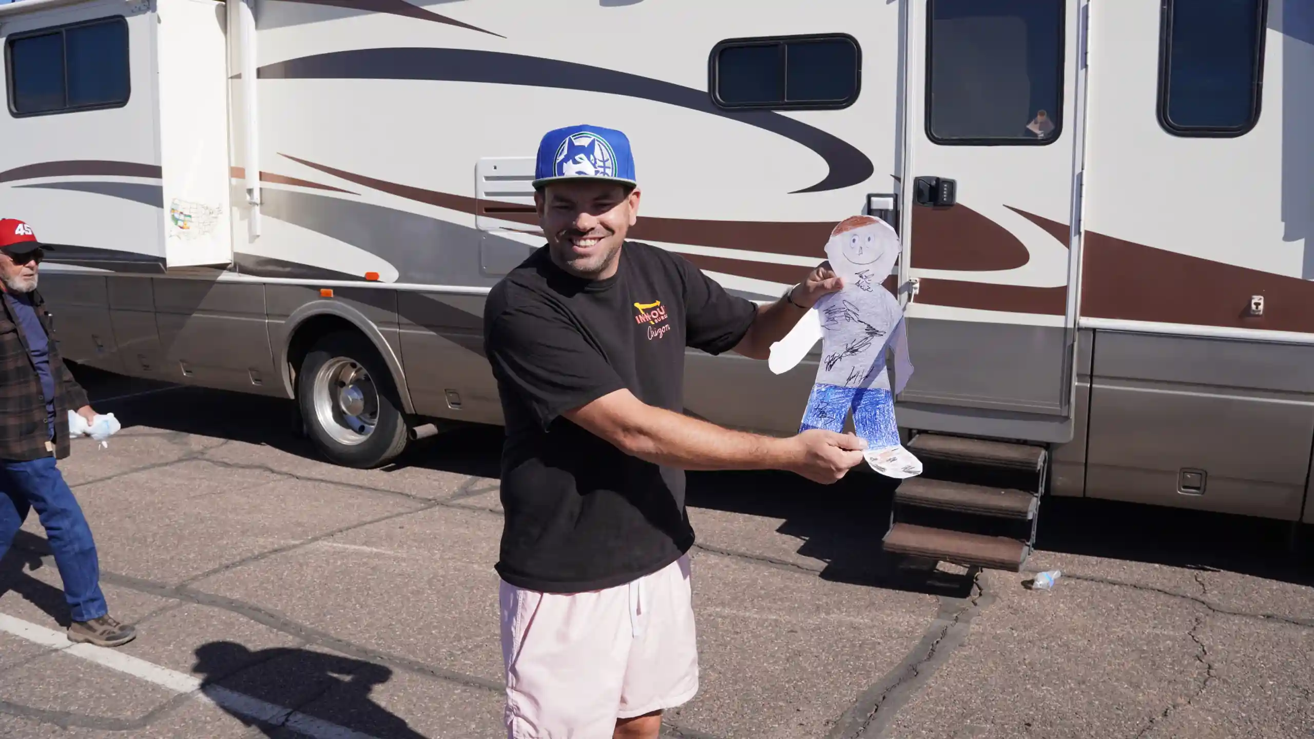Fan collecting autographs at a NASCAR race