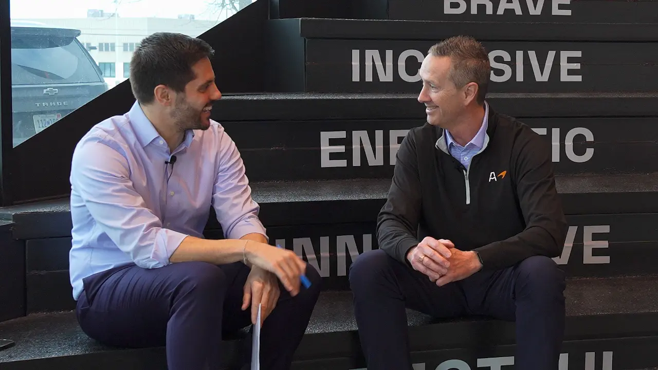 Kevin Thimjon speaking with Greg at the McLaren Racing Center
