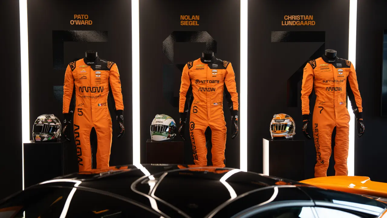 Race suits and helmets for Pato O'Ward, Nolan Siegel, and Christian Lundgaard